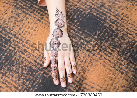 Beautiful henna design on back hand