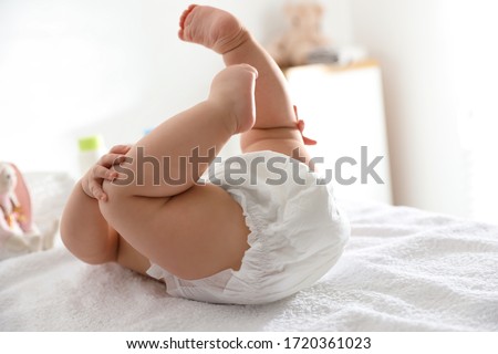 Cute little baby in diaper on bed Royalty-Free Stock Photo #1720361023