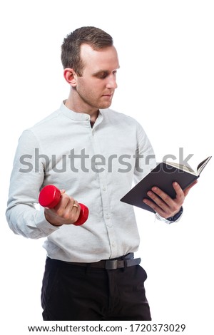 Caucasian man businessman, a teacher mentor. He is holding a diary and red dumbbell. He is wearing a shirt. Emotional portrait. Isolated on white background
