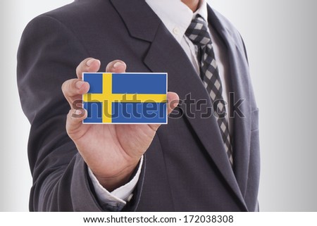 Businessman in suit holding a business card with Sweden Flag 