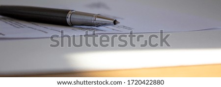Document and pen on beautiful white table. Warm sunlight. Concept background.