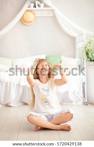 Little girl scratching her hair from lice or allergies. Irritated young girl scratching her head for nervous disagreement. Child itchy his hair or frustrated in bedroom. Angry kid in kindergarten. 