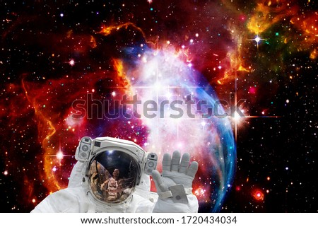 Astronaut and galaxy on the backdrop. The elements of this image furnished by NASA.
