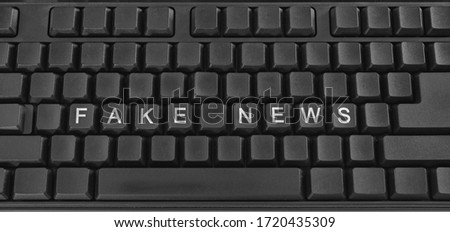 Text on PC keyboard - fake news. Minimal concept. 
