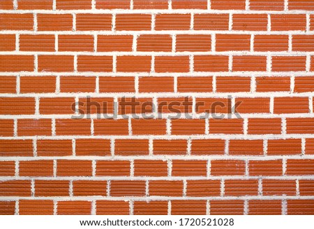 Old and aged red brick wall texture background with vignetting
