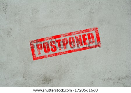 Postponed concept for business meeting, website advertising and others. Red "POSTPONED" stamping over grunge surface. Royalty-Free Stock Photo #1720561660