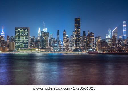 New York City Cityscape during Night Time with busy skyline and dense skyscrapers filling up the sky Royalty-Free Stock Photo #1720566325