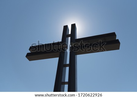 Iron catholic cross against blue sky. Rossoschka German War Cemetery. Volgograd. (Stalingrad). Russia.
