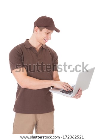 Young Delivery Man Using Laptop Over White Background