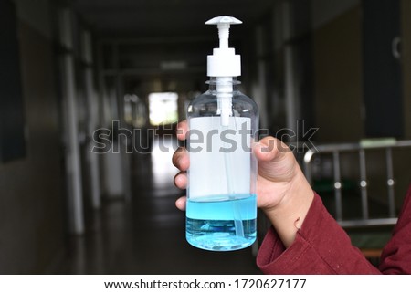 Alcohol bottles for hand washing to protect against the Corona virus 19 held by the boy's hand.