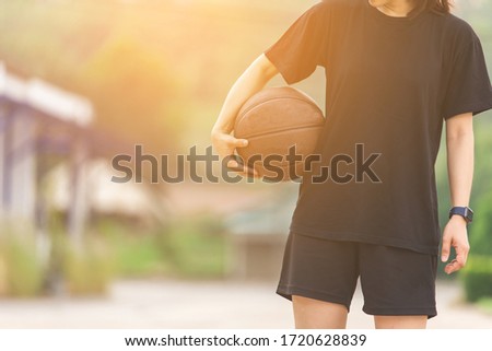 Young woman holding a basketball
