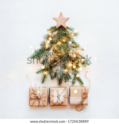 Zero Waste Christmas concept. Christmas tree made of natural fir branches with wooden star and paper lace gift.