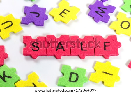 word SALE formed with colorful foam puzzle  on white background 