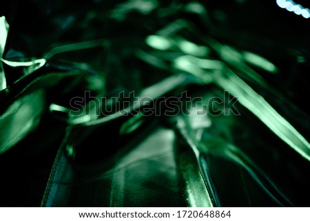 Bright green holographic neon foil background. Multicolor trendy backdrop. Copyspace top horizontal view
