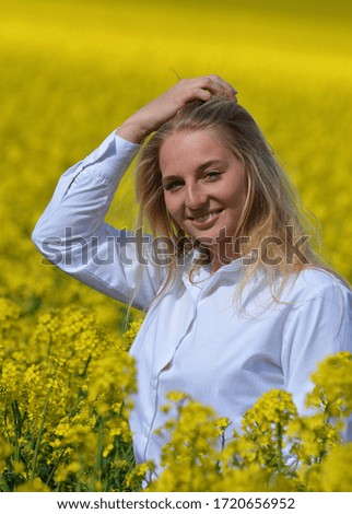 Young blonde in a rapeseed field