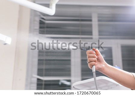 Dentistry, dental health and medicine concept - Close-up of dentist's hand holding a dental tool instrument.