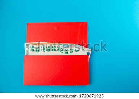 red box with savings euro banknotes on a blue background