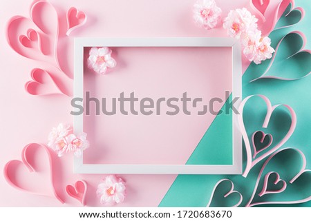 Happy Mother's Day, Women's Day or Valentine's Day greeting concept. Pastel Pink Colours Background with picture frame, handmade heart and blossom flowers flat lay patterns.