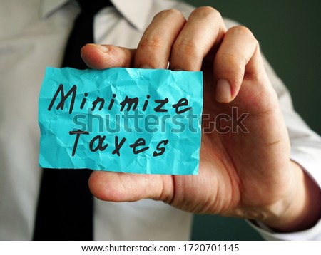 Financial concept about Minimize Taxes with sign on the piece of paper. Royalty-Free Stock Photo #1720701145