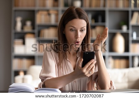 Surprised woman with open mouth looking at phone screen, reading unexpected message, shocked young female received unbelievable news, getting job promotion, online lottery win, success Royalty-Free Stock Photo #1720702087