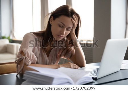 Tired sleepy woman sitting at desk with laptop, holding head, resting on hand, sleeping at workplace, bored young female feeling drowsy, lazy and unmotivated student, boring job, lack of sleep Royalty-Free Stock Photo #1720702099