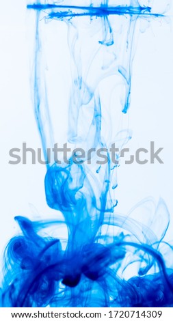 Dark Blue colors dropped into liquid and photographed while in motion. Cloud of silky ink in water on white isolated background, an abstract banner. Ink swirling in water. Abstract background color