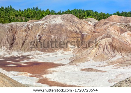 Landscape like a planet Mars surface. Solidified red-brown black Earth surface. Cracked and scorched land. Refractory clay quarries. Natural background.