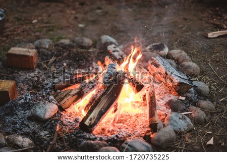 Bonfire with the stones in the glamping park 