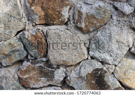 Natural stone wall, rough surface, dark gray, rough, looks strong