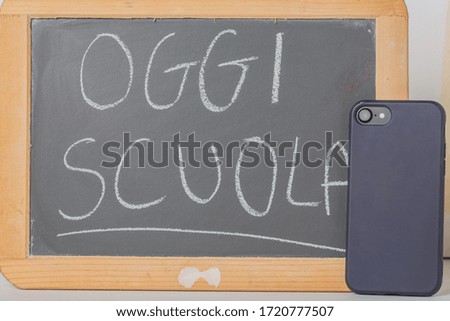 Little blackboard and smartphone on white background