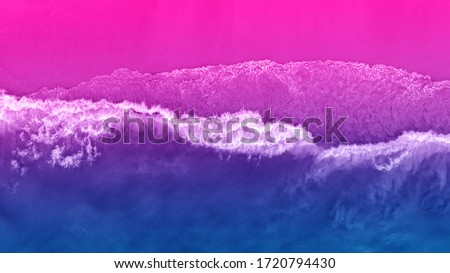 Bright colorful top view of the beach in ultraviolet neon color. Unusual combination of colors. Magical atmosphere.