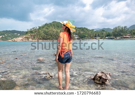 Portrait young beautiful thai lady walk smile and happy on the beach sea and ocean for leisure travel in holiday vacation