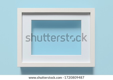 Close-up of white frame on light blue background