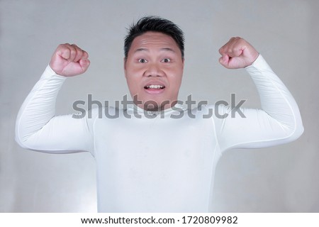 portrait muscular man, big body wearing white track suit, the concept of bodybuilding men 