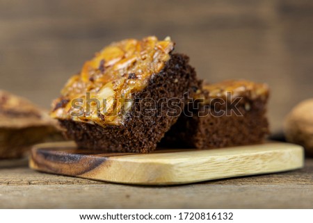 Close up toffee cake on wooden tray and on wooden table background.