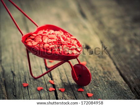 Wheelbarrow with Tiny Hearts, on Wooden Background