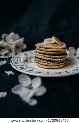 pancakes with bananas in a white plate