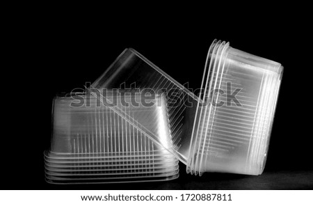 Plastic containers on black background.It is black the white photo                          