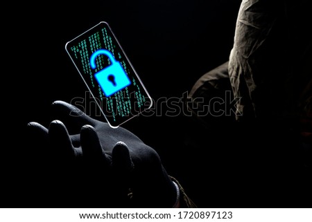 Cyber Criminal Issue concept of illuminate Unlock Safety icon with green binary code on screen of Mobile phone floating above of Hacker hand in dark background Royalty-Free Stock Photo #1720897123