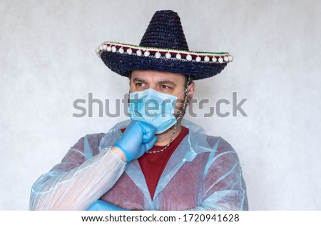 end of quarantine coronavirus COVID-19. man in a medical mask. hand with medical glove.  guy wears a Spanish or Mexican sombrero. Lockdown. national mask mandate