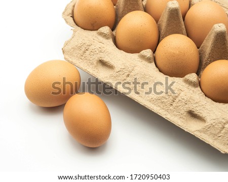 Organic eggs with a cardboard package on a white background close-up photography