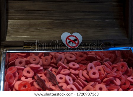 Pink gummy candy in pirate crates with sign"don't touch" on it.