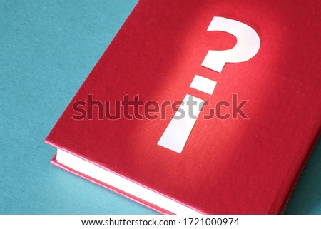 Question and exclamation marks are connected on the red book. important book opening the solution to the problem