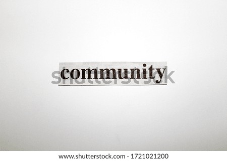 Picture of the word 'community' written in ink on a white background