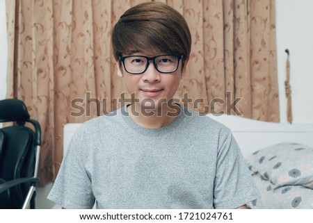 Young asian man looking at video camera and happy to talk with family and friends via internet video call. Stay home to avoid and protect from Covid-19, corona virus. Royalty-Free Stock Photo #1721024761