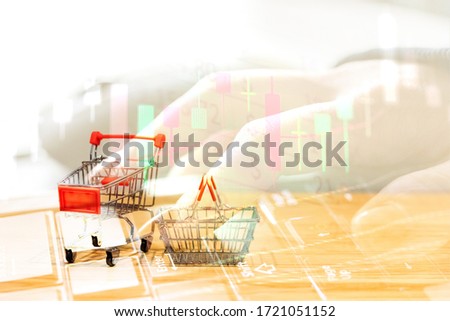 Shopping cart or Supermarket trolley stay with the stack of coins on white background, For business and finance background. Trend to shopping online in 2020 marketing