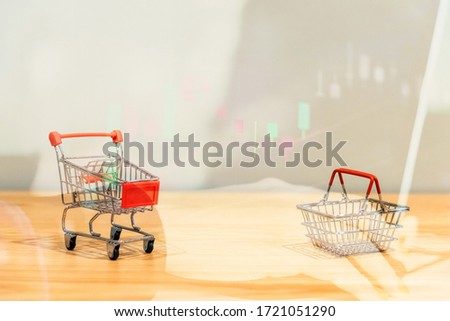 Shopping cart or Supermarket trolley stay with the stack of coins on white background, For business and finance background. Trend to shopping online in 2020 marketing
