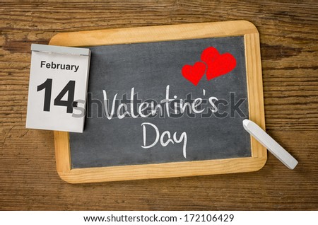 Calendar and blackboard showing February 14, Valentine's day  Royalty-Free Stock Photo #172106429
