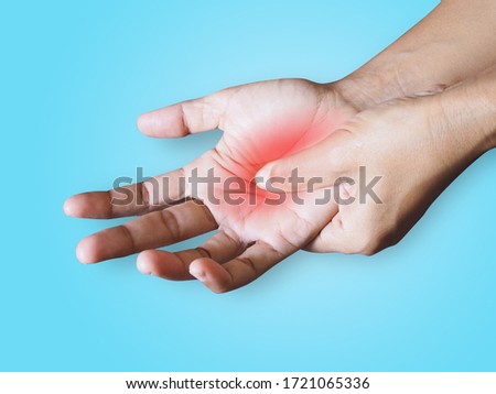 Injury with hand pain isolated on blue background with clipping path.