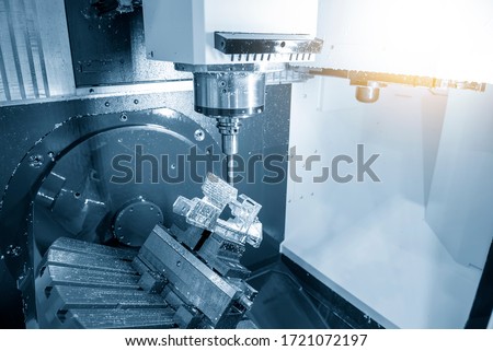 The  5 axis CNC milling machine cutting the  automotive parts with solid ball endmill tools. The hi-technology automotive part manufacturing process by 5 axis machining center. Royalty-Free Stock Photo #1721072197
